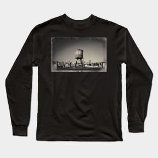 Sepia-toned image of a rusty water tower on a rooftop of Queens, in New York City, with the Queensboro Bridge and the Manhattan skyline in the background. Long Sleeve T-Shirt